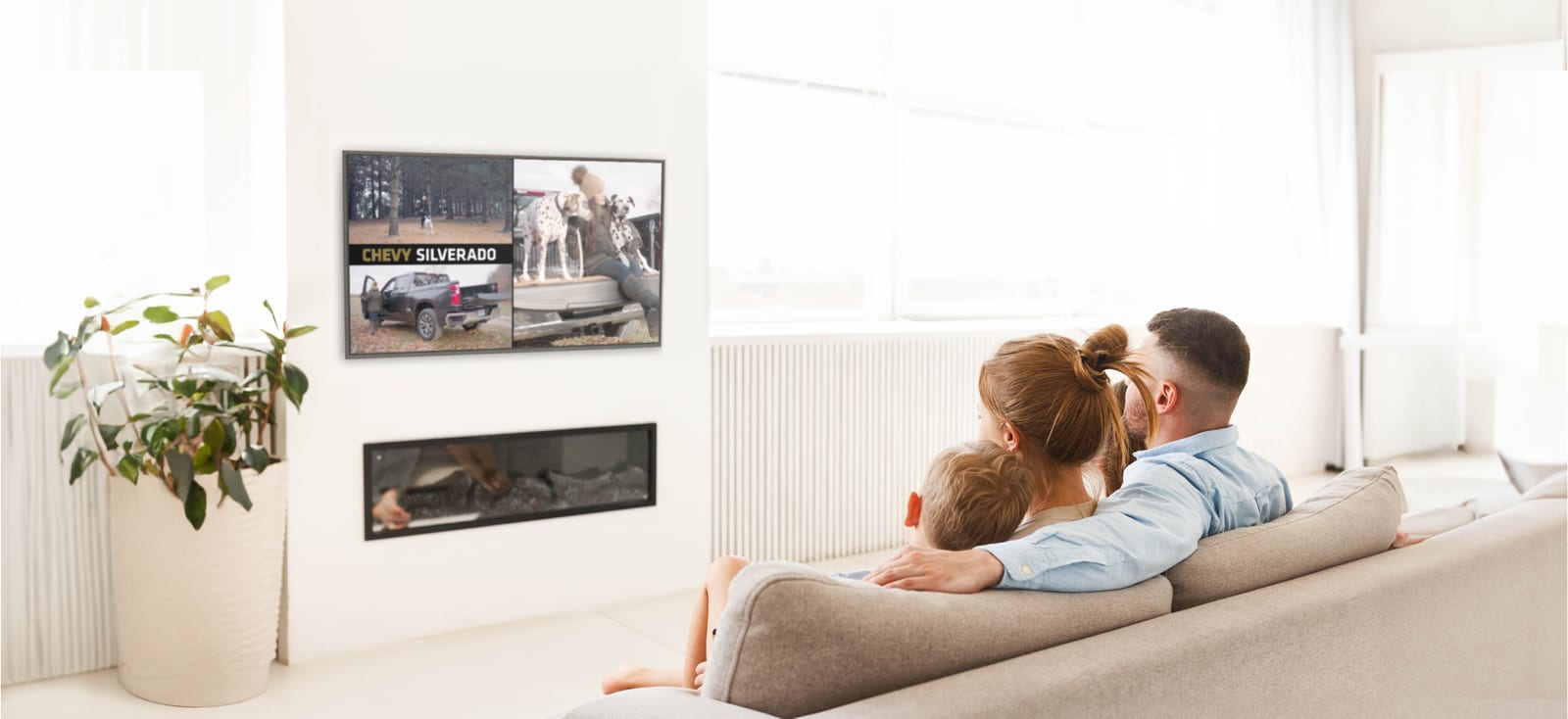 Family watching Chevy Silverado commercial on their couch