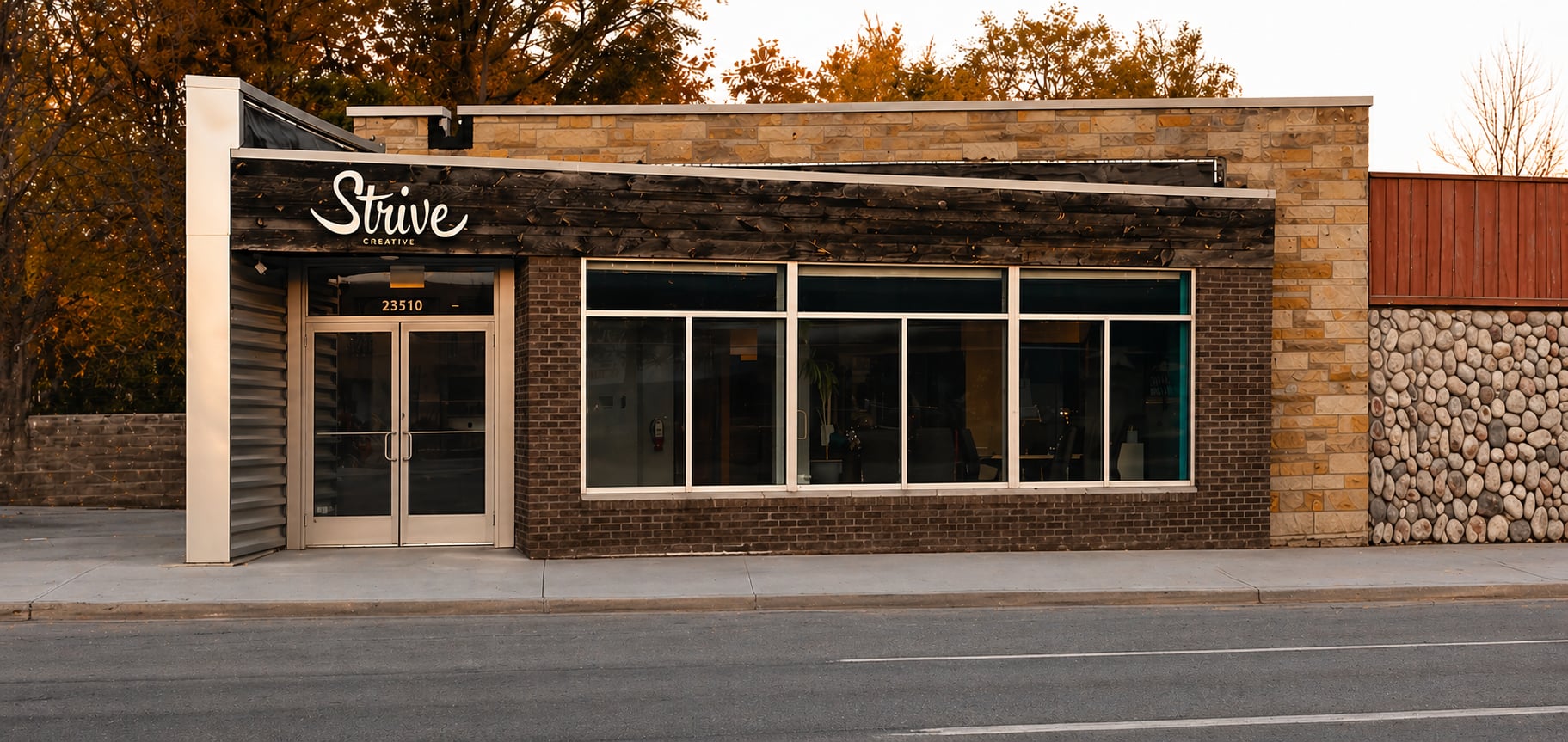 Strive Creative office storefront from across the street at dusk