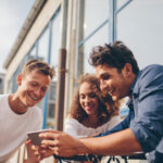 Emotional Marketing - group of friends surrounding a phone